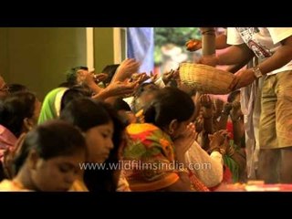 Devotees offering puspanjali to Maa Durga