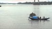 Boatmen steering boat in Hooghly River