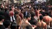 Shia Muslims flagellate themselves at Muharram procession