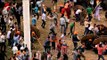 People fighting a battle in front of the temple, throwing stones at each other