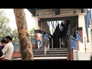 People in quick motion at Jahangir Puri metro station