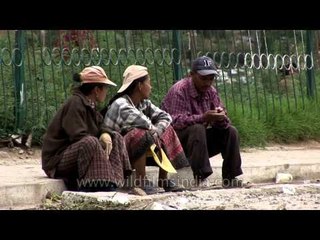 Bhutanese sitting on footpath in Bumthang, Bhutan