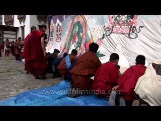Monks folding the Thangkha displayed at Kurjey Festival in Bamthang