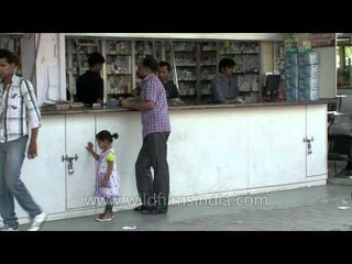 Cute girl standing patiently at medicine store near AIIMS hospital