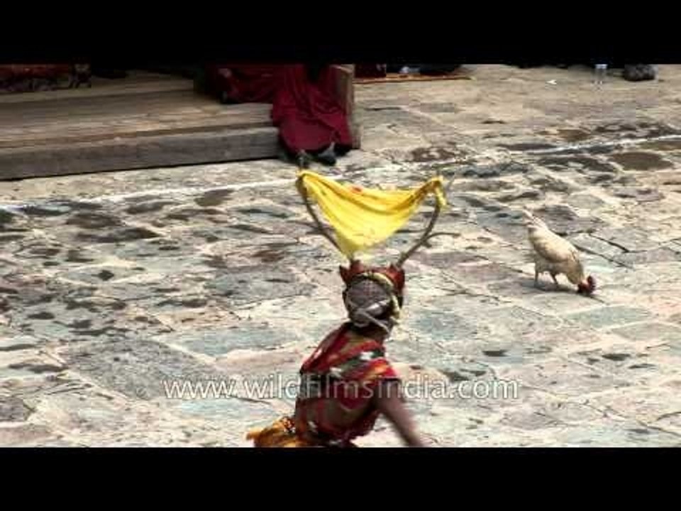 Cham dancer swrils holding a stick as apart of Peling Ging sum dance in Bhutan