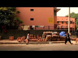 Kids placing pottery products on footpath in Sarojini Nagar