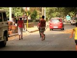 Young boy balancing charpoy or khatia on his head in Sarojini Nagar