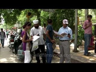 Filling application forms under the hot sun