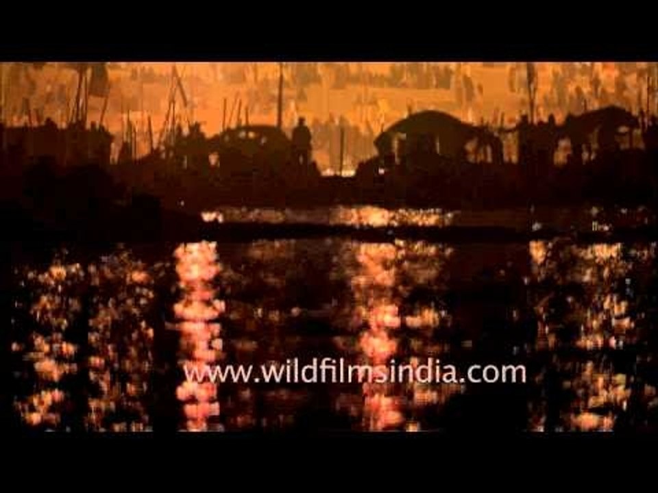 Priest lighting the lamps for aarti at Sangam