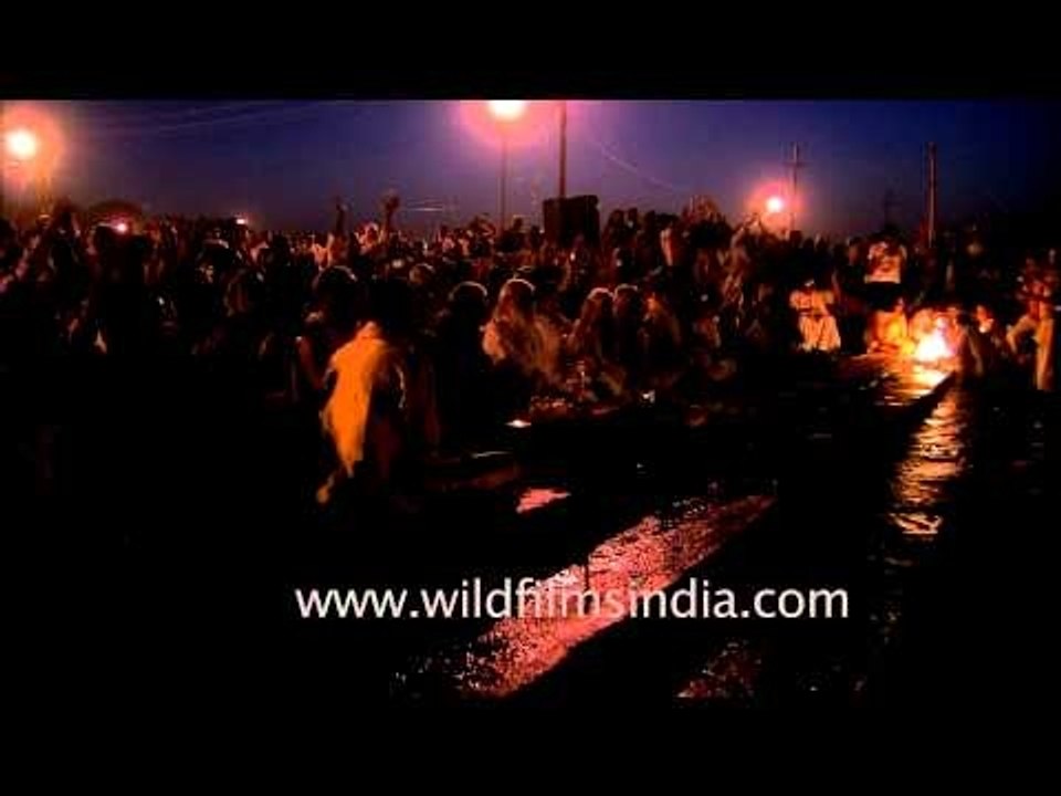 Priest prepares a traditional oil lamp before performing evening prayers Maha Kumbh site, Allahabad