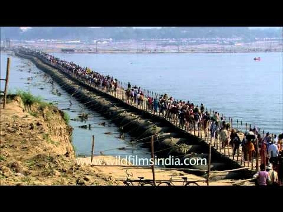 Pilgrims walk across pontoon bridges at Maha Kumbh festival