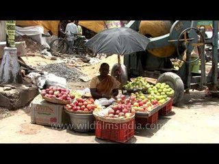 Women selling varieties of fruits at a market in Vellore