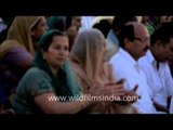 Hindu female saint singing bhajans at Triveni Sangam during Maha Kumbh