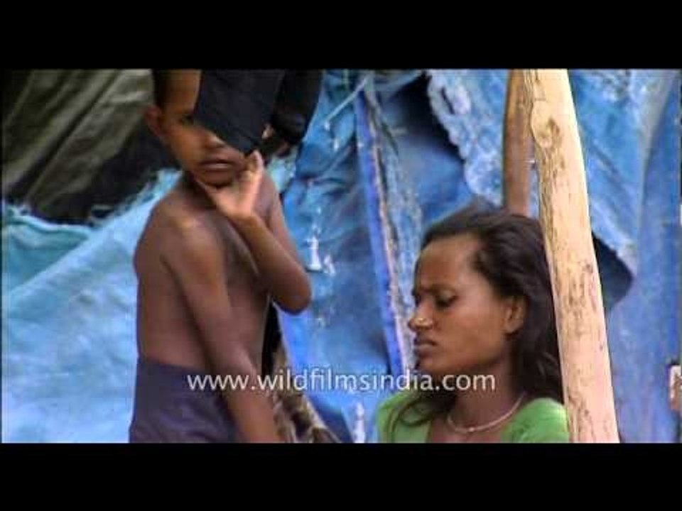 A mother dressing her son