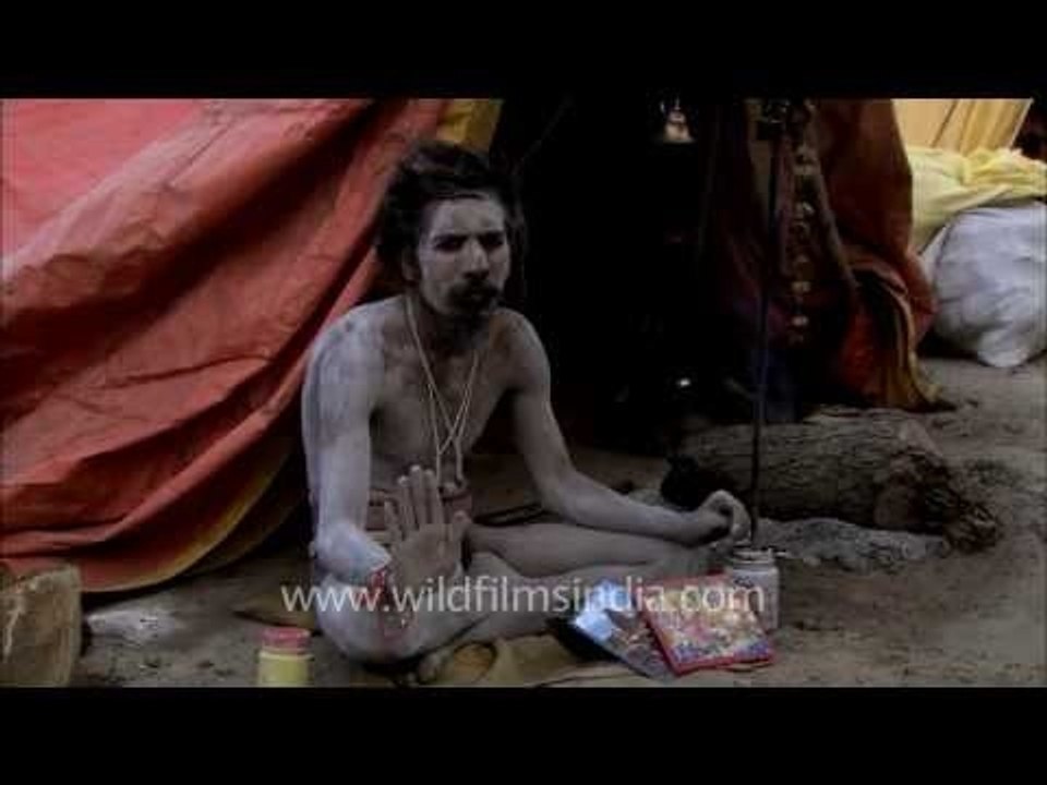 A naga sadhu with some of the traditional items of his vocation, Varanasi