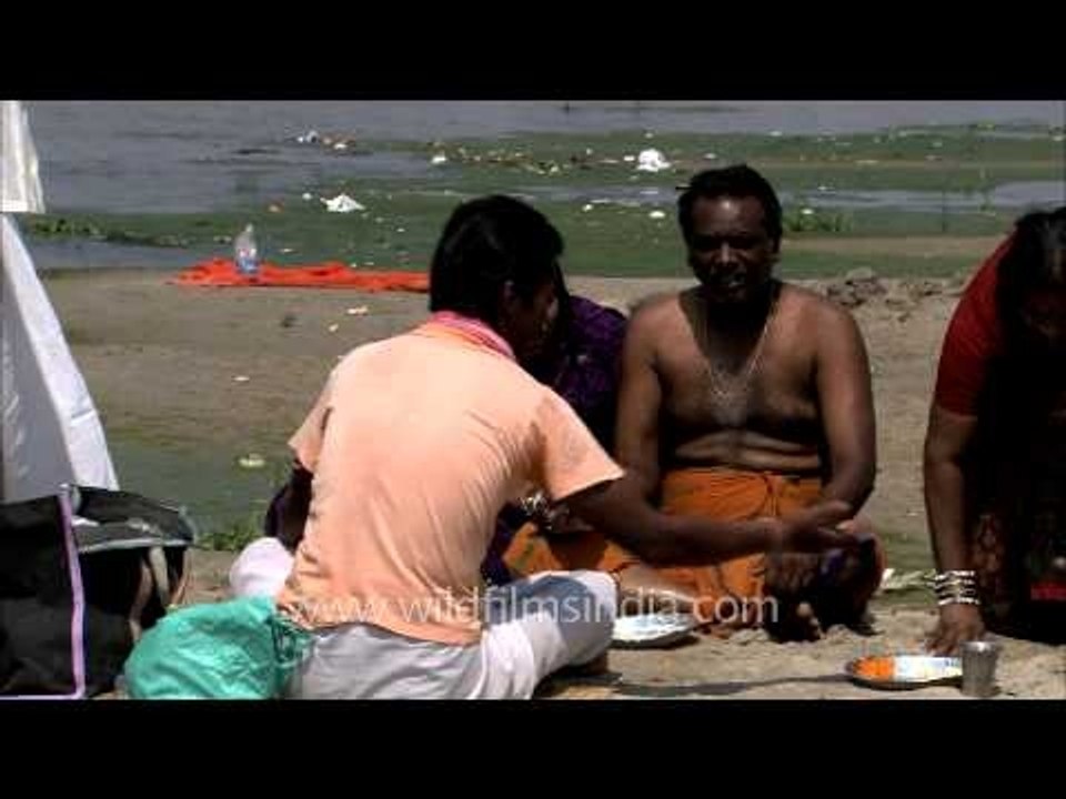 People performing Hindu ceremony at ghats of Varanasi