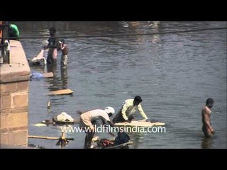 People wash clothes in the holy scared water of Ganga, Varanasi