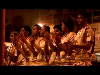 Priests singing devotional song at the Ghat of Varanasi