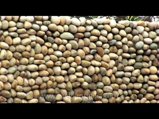 Stoned wall with the replica of birds on top at Rock Garden in Chandigarh