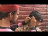 Cure for a dirty itchy waxy ear: a street-side ear cleaner!