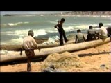 Man falls down carrying heavy bundle of fishing net
