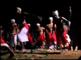 Men in red white lungis dancing during Padayani Festival
