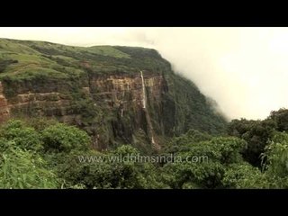 The mist rises to hug the greens while the falls spray away, Cherapunji