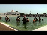 Sikh devotees performing holy bath on Baisakhi at the sarovar in Gurudwara Takht Sri Kesgarh Sahib