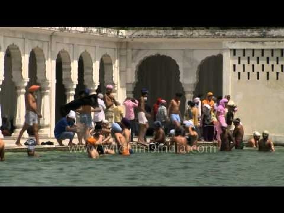 Devotees taking holy dip in the sacred Sarovar at Gurudwara Takht Sri Kesgarh Sahib.