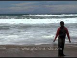 Man walking along the beach side