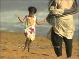 Walking barefoot along a sandy beach in Thiruvananthapuram
