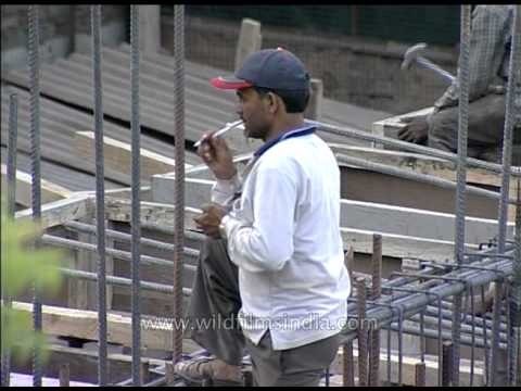 House construction workers busy constructing house in Delhi