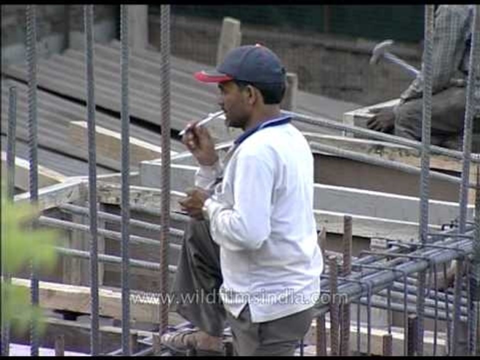 House construction workers busy constructing house in Delhi