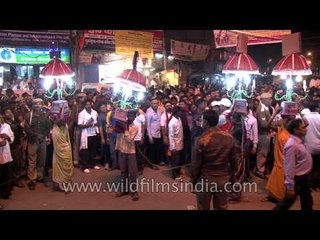 Portable human lamp holders at the Maha Shivratri procession in Varanasi