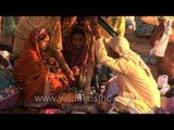 Priest performing Hindu rituals with new born baby and his family during Maha shivratri at varanasi