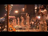 Hindu priests performing the Ganga Aarti as spectators watch in awe at Varanasi