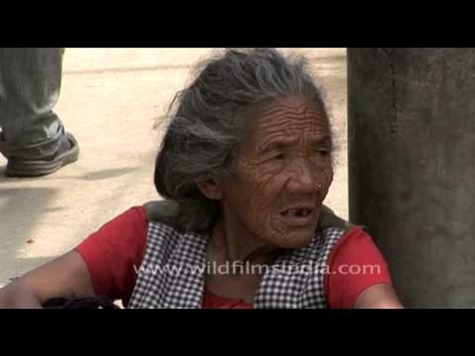 A weathered old lady on a road in Nepal