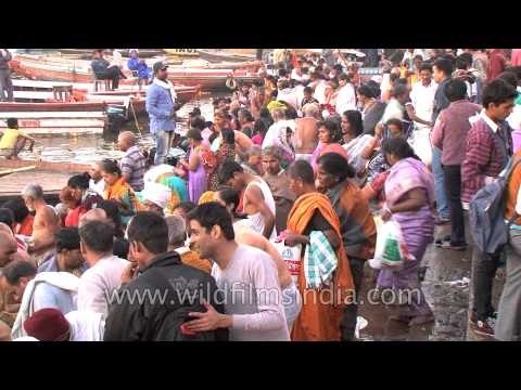 Pilgrims wait for turns to take a holy dip in river Ganges during Mahashivaratri festival