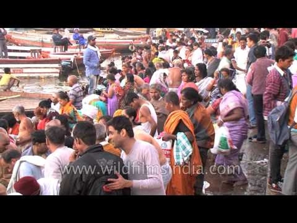 Pilgrims wait for turns to take a holy dip in river Ganges during Mahashivaratri festival