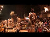 Hindu priests ceremoniously waving fly whisk during Ganga Aarti in Varanasi