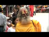 Woman flower seller and Sadhu in the streets of Kathmandu, Nepal