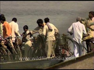 Ferry boat on Yamuna river transporting cyclists across in Delhi