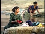Maldhari women wash clothes by the river