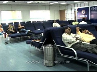 Passengers wait to board at departure lounge, Bombay airport