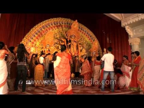 Devotees standing around the idle of Goddess Durga on Durga Puja