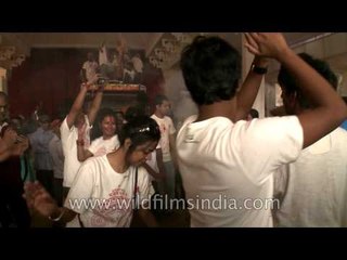 Devotees performing traditional dance during Durga Puja celebration