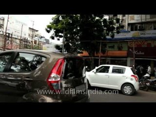 Driving along busy shopping area in Pune