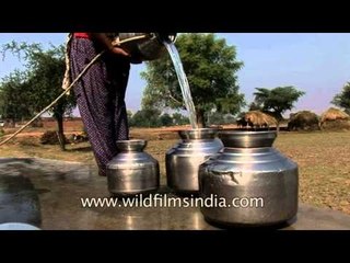 Villagers collecting water from bore well using a pulley in Uttar Pradesh