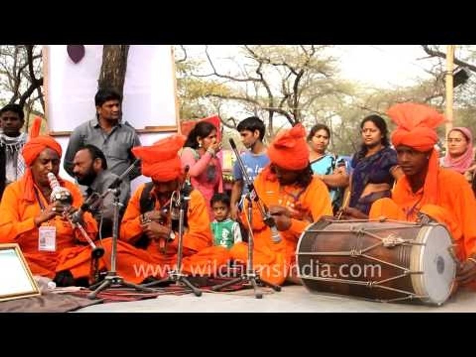 Folk musician compiling beats with traditional instruments at Surajkund Mela 2013