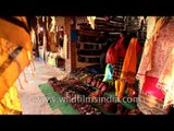 Intricately embroidered shawls and shoes store at Dilli Haat